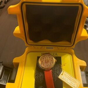 Invicta watch  red leather band
Face has a daisy style print
The case is yellow